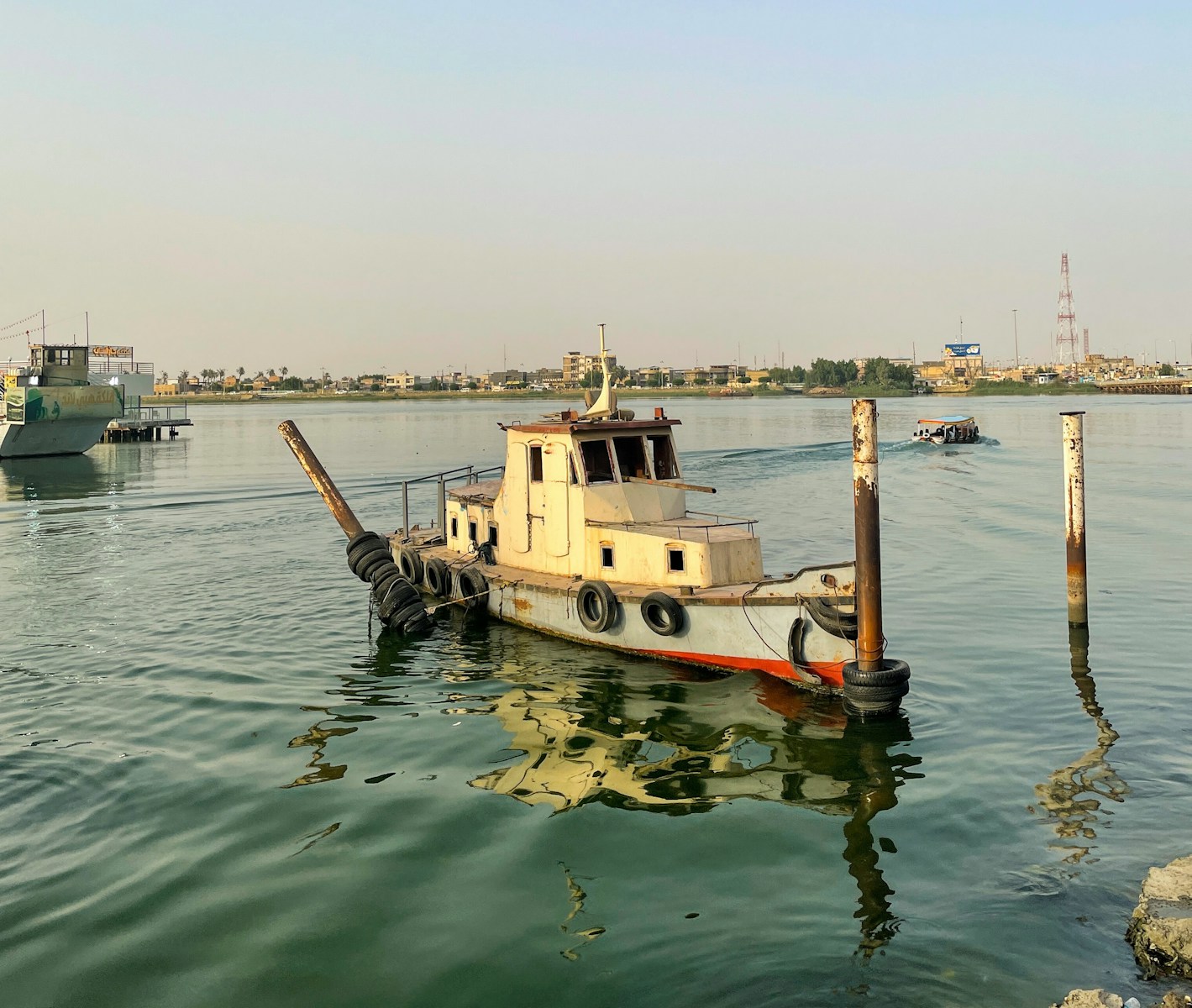 a tug boat in the middle of a body of water