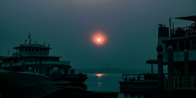The sun is setting over a body of water