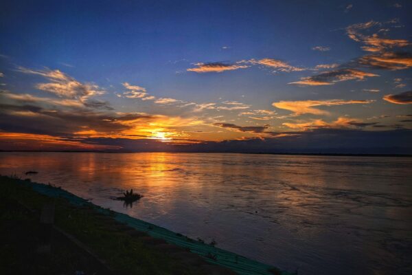 the sun is setting over a body of water