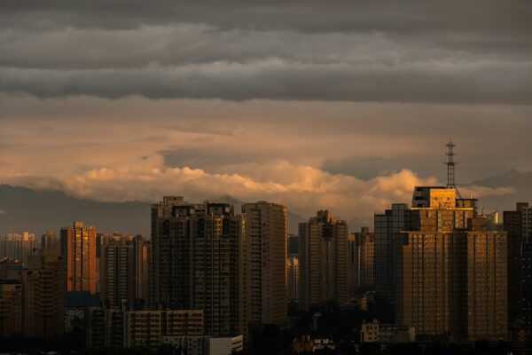 city skyline under cloudy sky during sunset