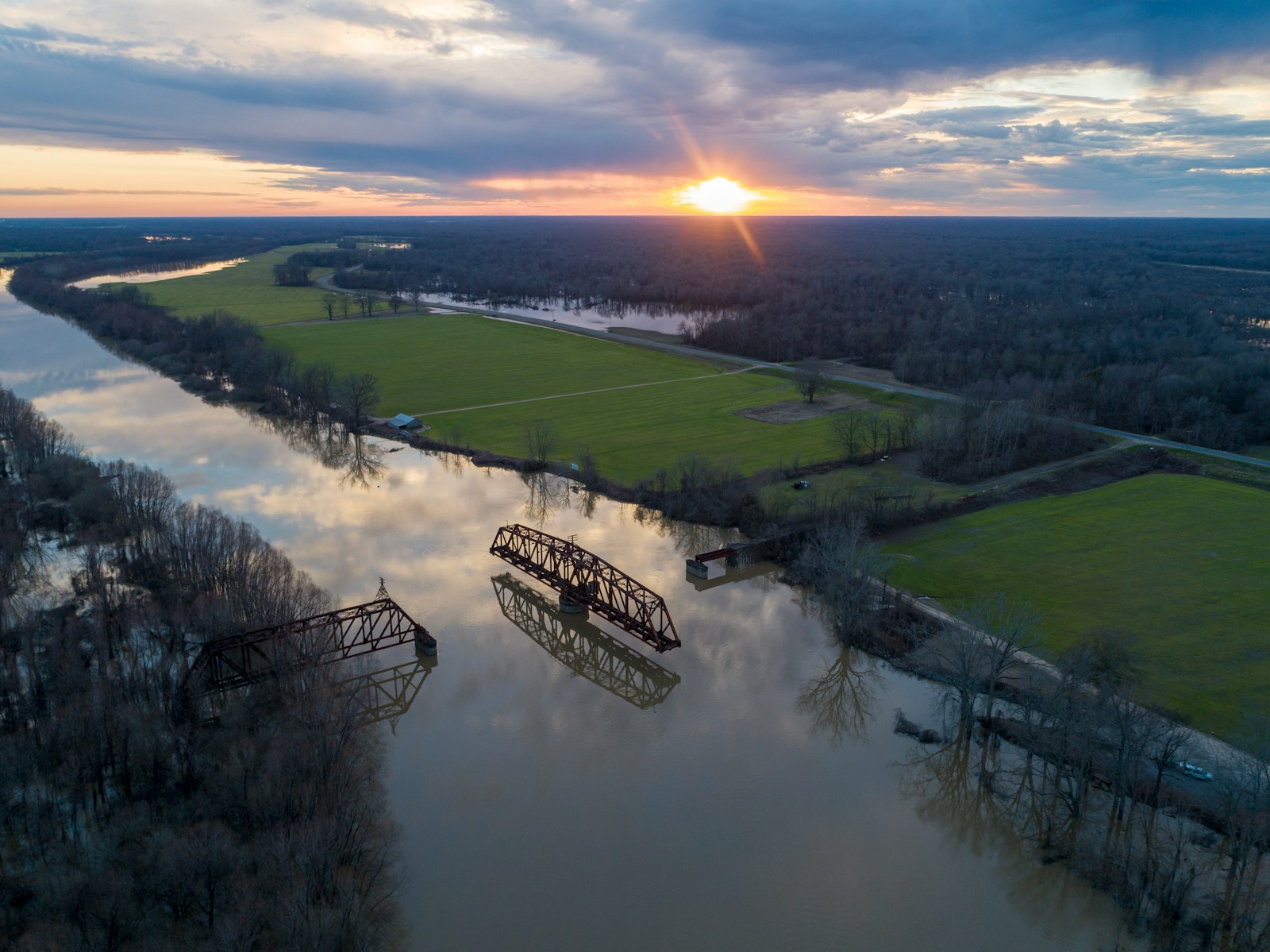 an aerial view of a river and a bridge