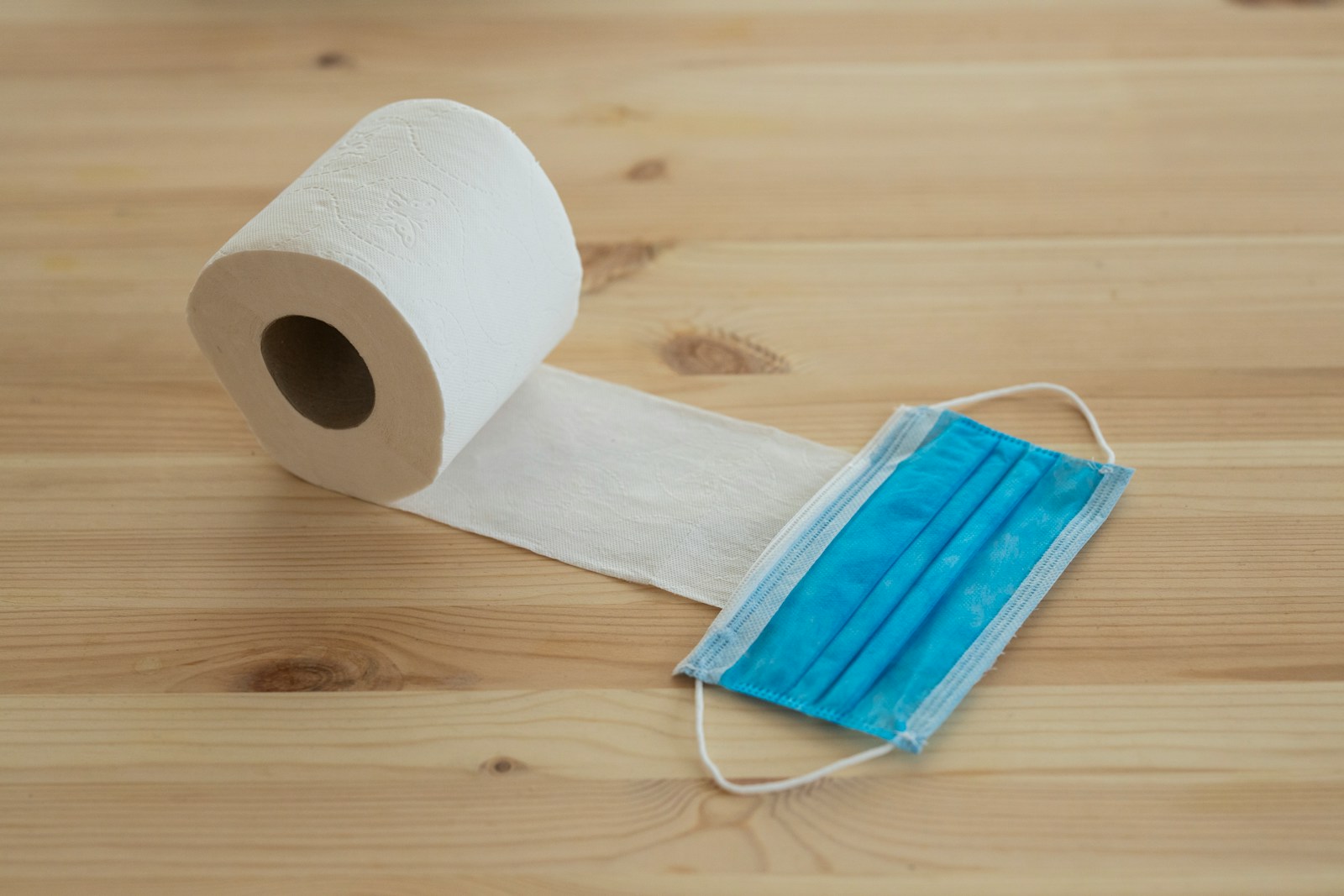 white toilet paper roll on brown wooden table