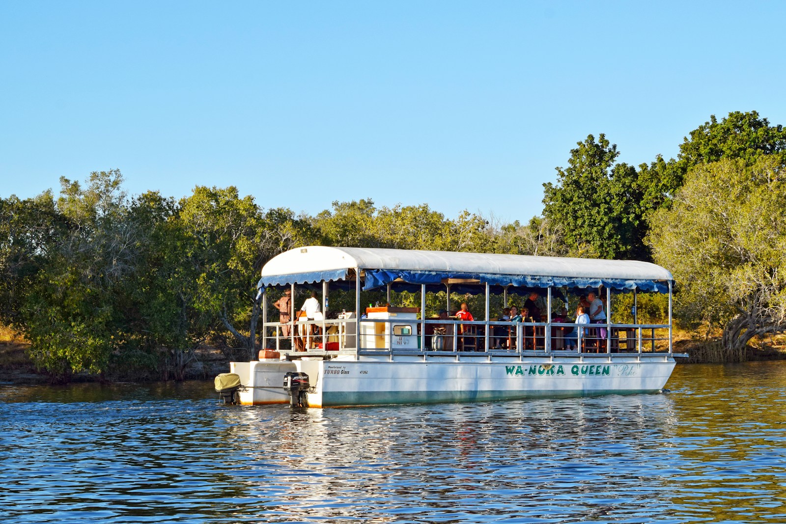 A boat with people on it floating on a lake