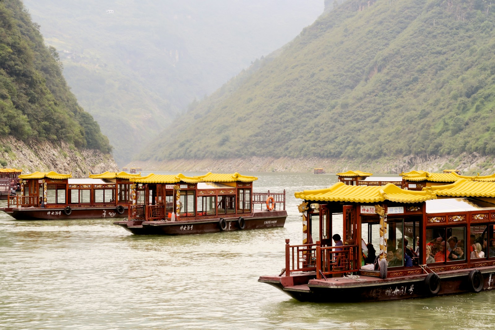 a group of boats floating on top of a river