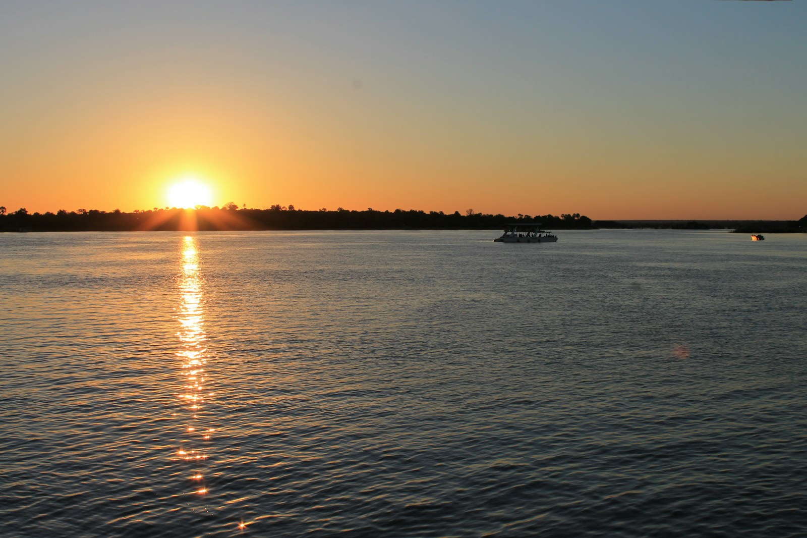 the sun is setting over a body of water