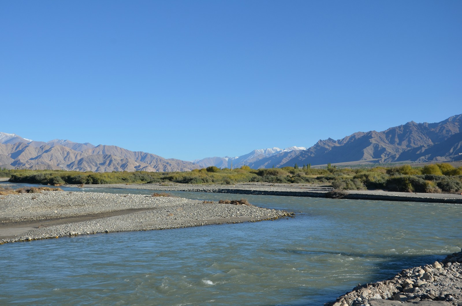 a river with mountains in the background