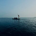 2 person riding on boat on sea during daytime