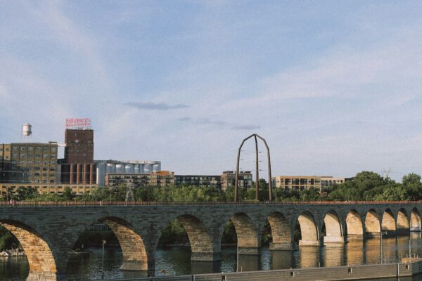 a bridge over a body of water with buildings in the background