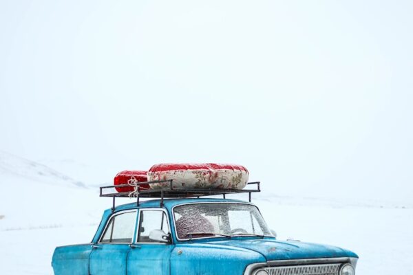 blue sedan on snow ground