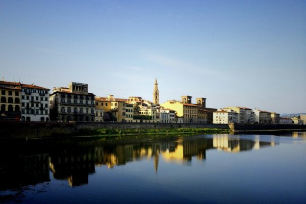 beige buildings near large body of water