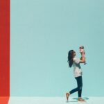 woman carrying baby while walking