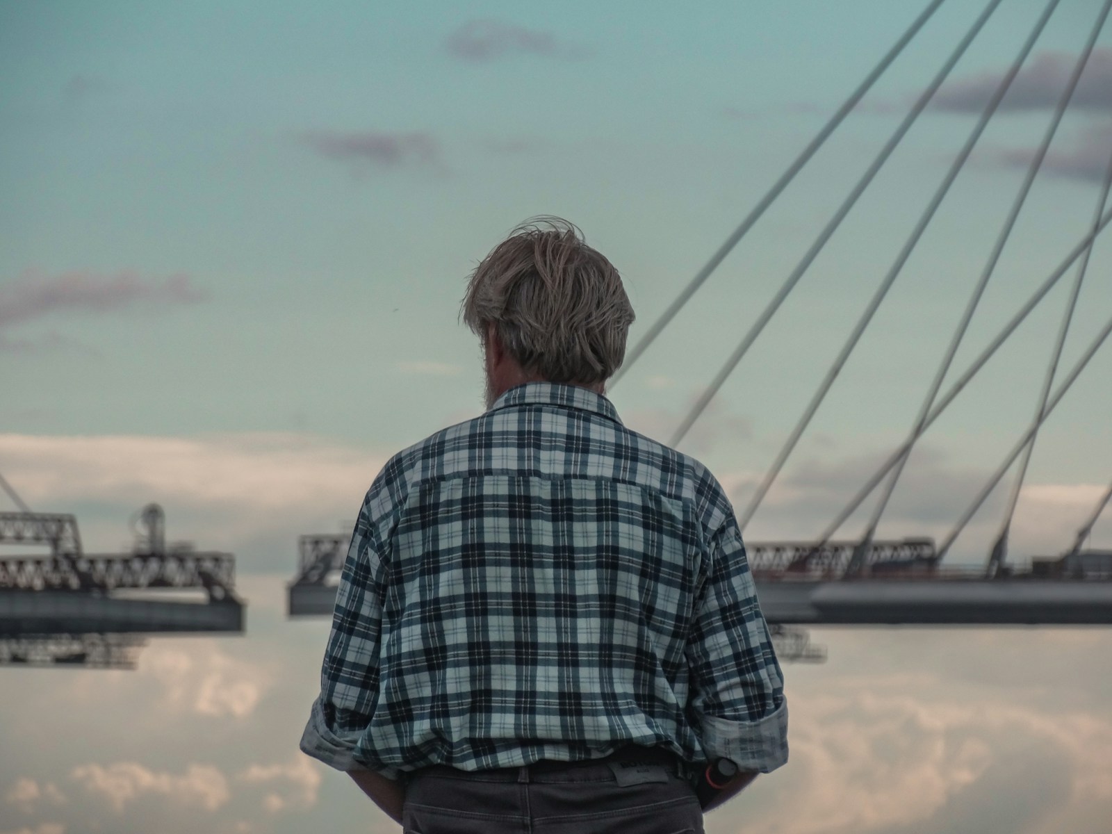 a man standing in front of a body of water