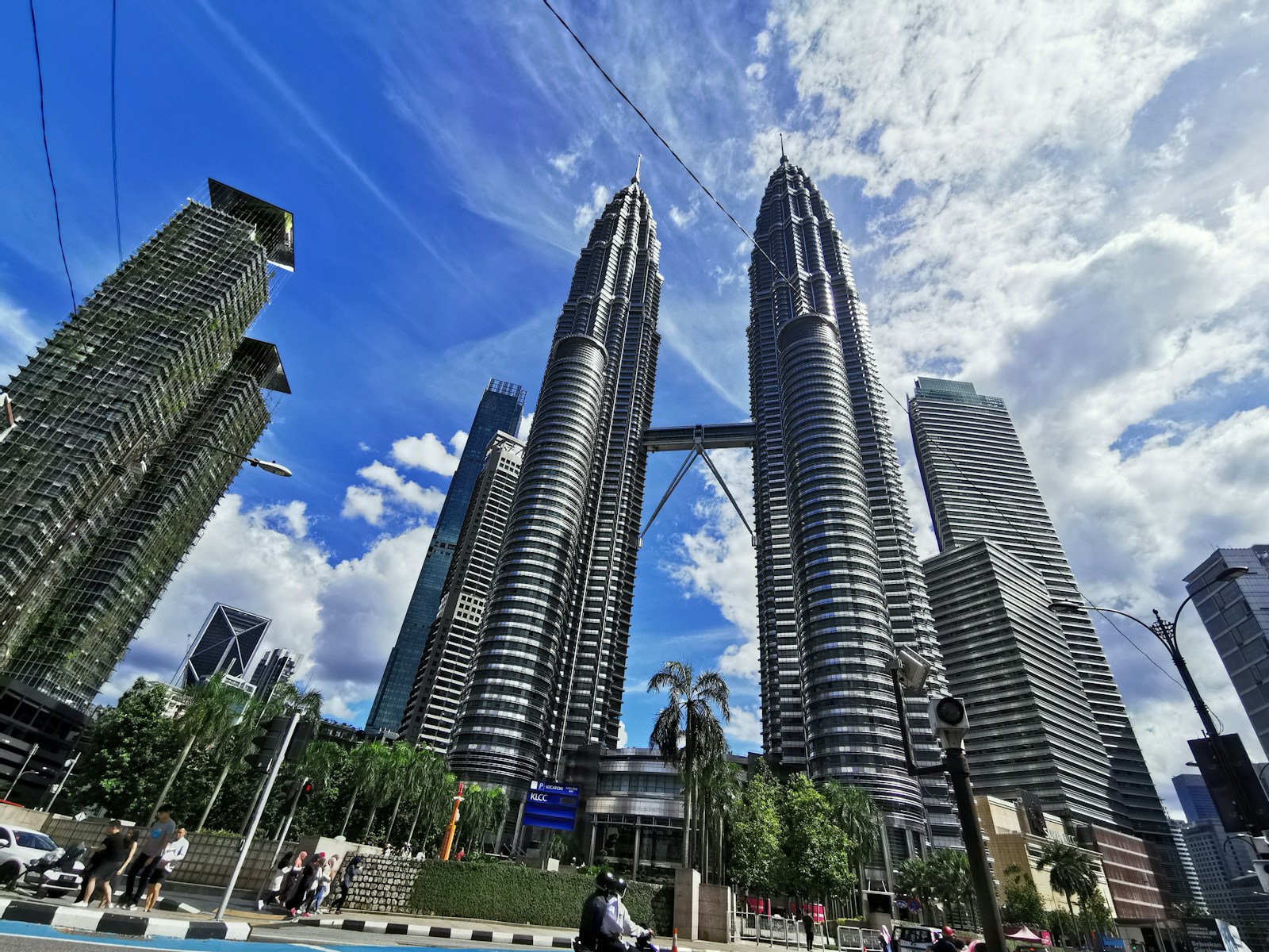 people walking on street near high rise buildings during daytime