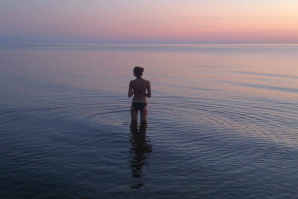 woman standing on body of water