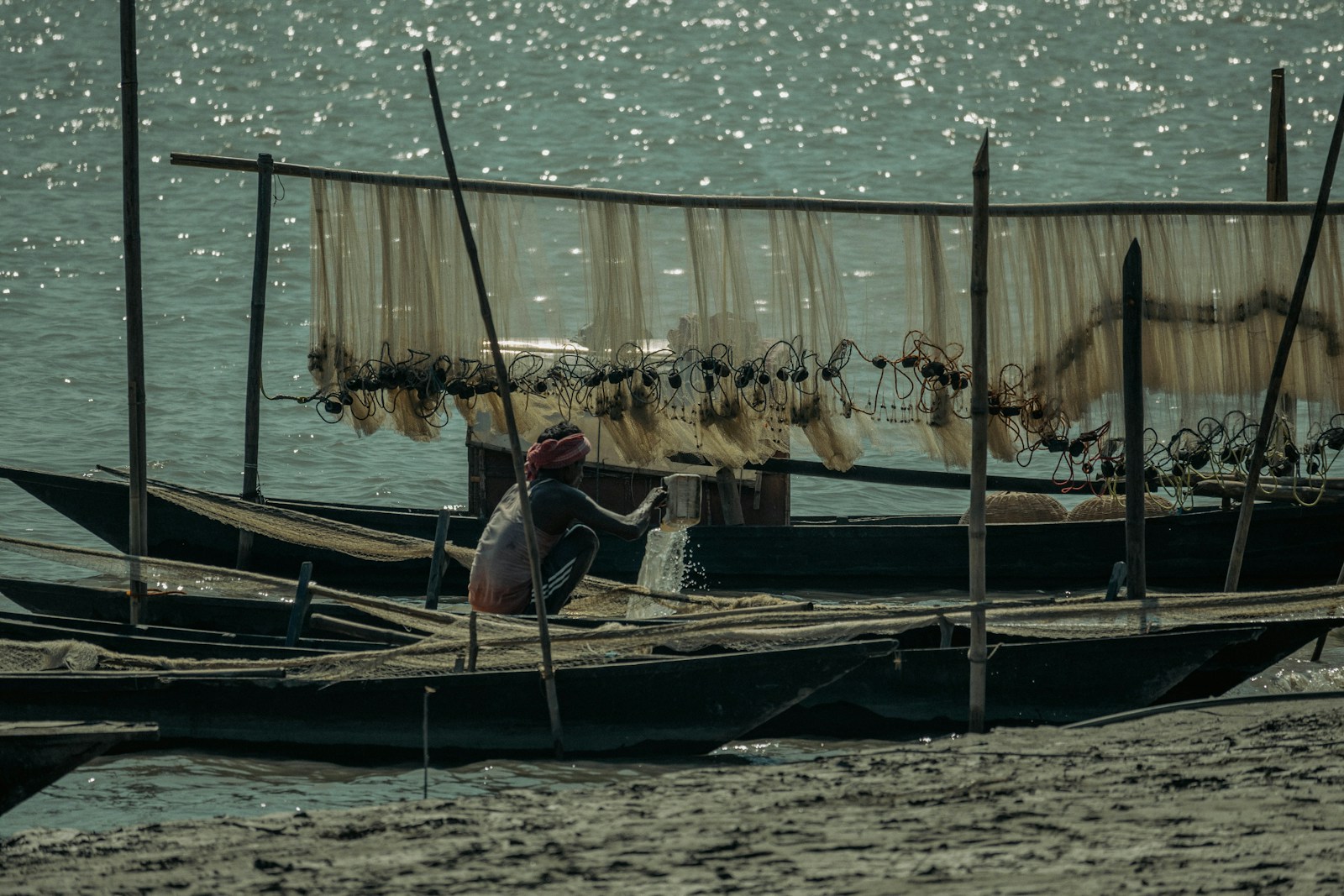 a man sitting on a boat in the water