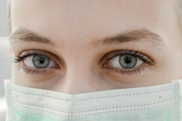 closeup photo of woman's eye wearing mask