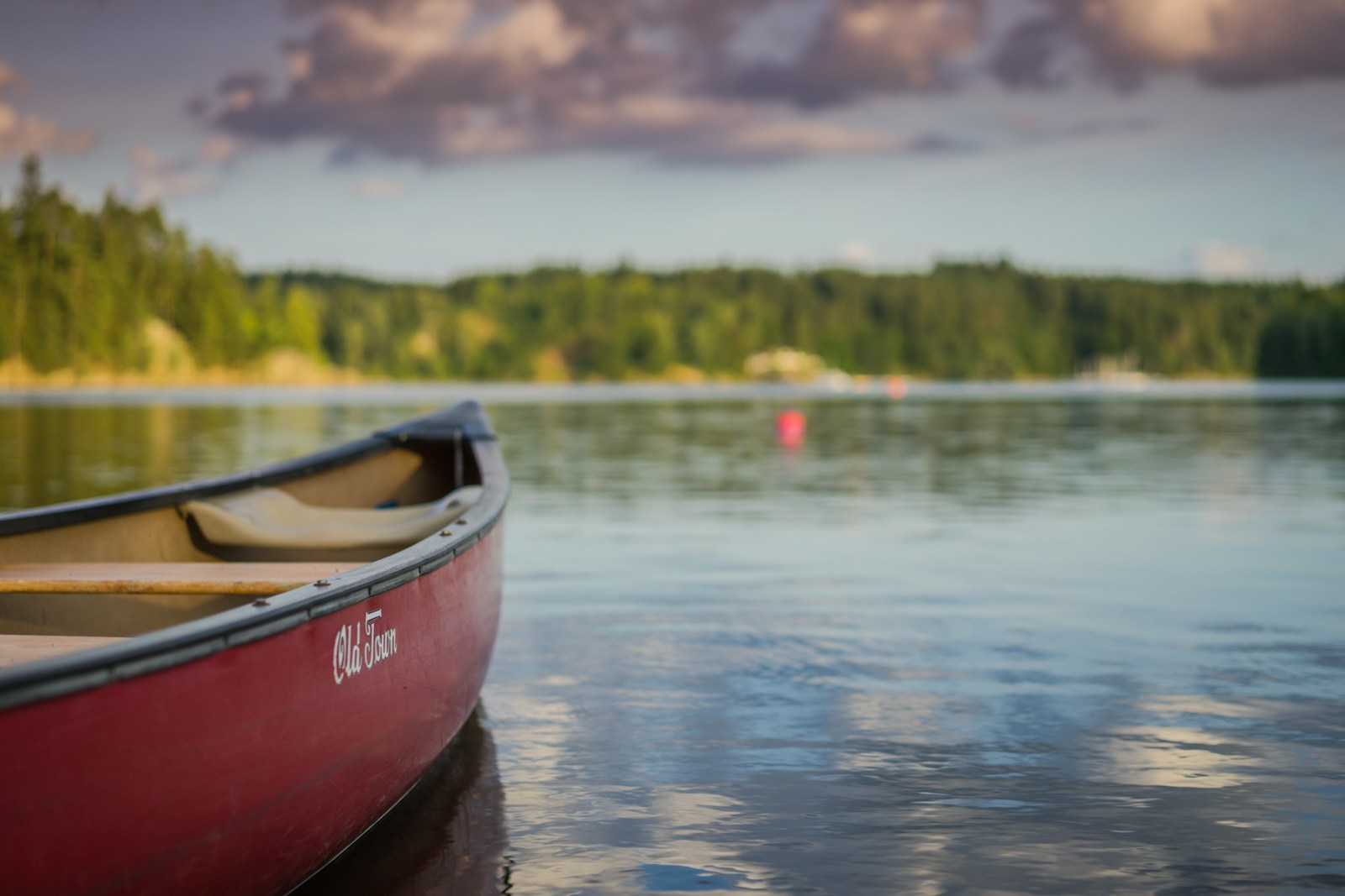 red canoe boat on body of water