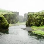 landscape photography of river between green mountains