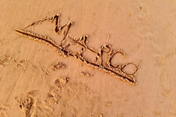 a word written in the sand on a beach