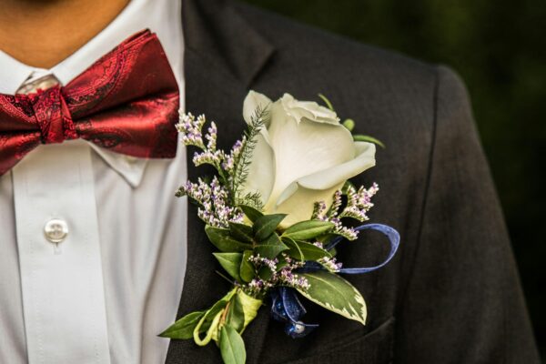 white rose on man's suit jacket