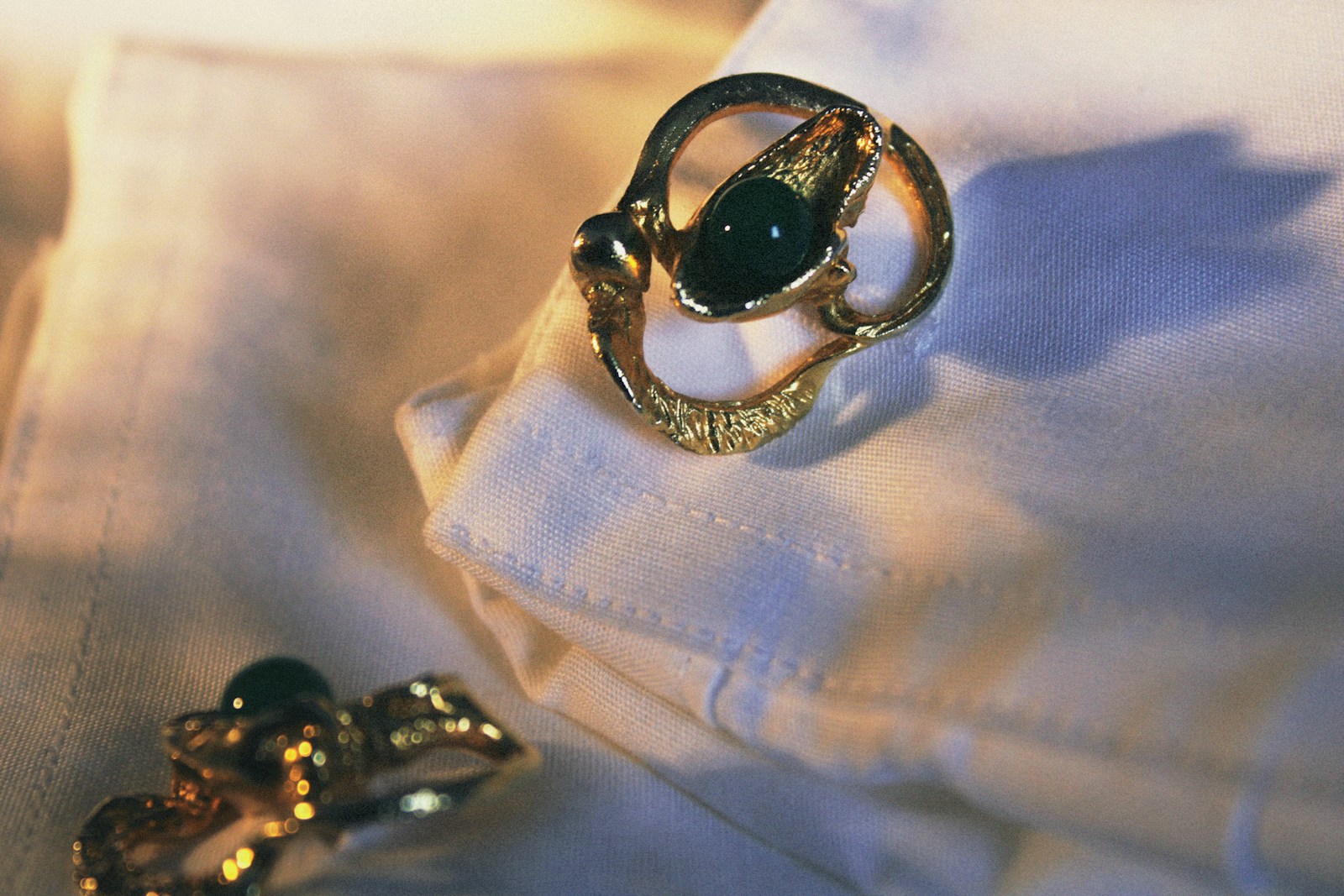 a pair of rings sitting on top of a white shirt