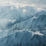 a view of snow covered mountains from an airplane