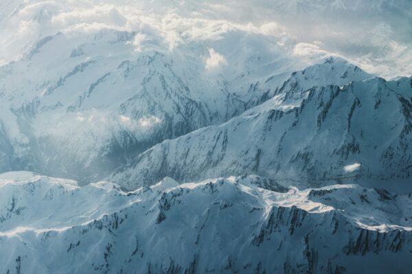 a view of snow covered mountains from an airplane