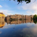 a large building sitting next to a lake