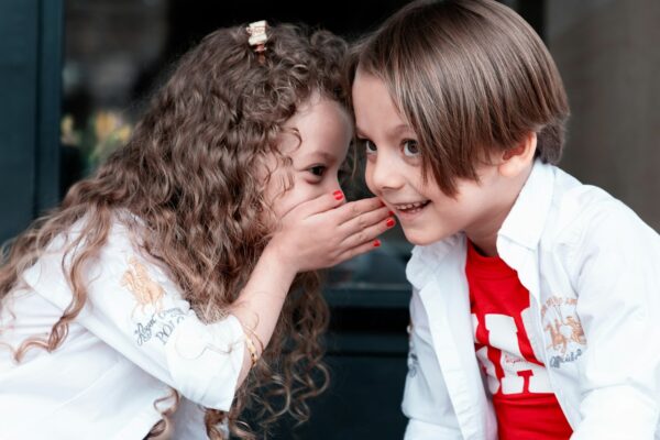 woman in white long sleeve shirt kissing girl in white long sleeve shirt