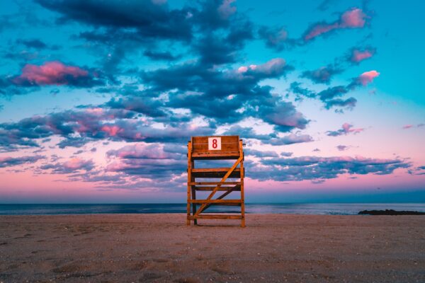 brown wooden stand on shore under gray sky