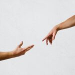 persons hand on white wall