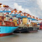 blue and red cargo ship on dock during daytime