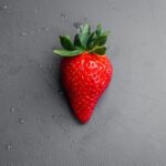 red strawberry on gray textile