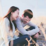 photo of man and woman laughing during daytime