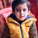 boy in yellow zip up jacket