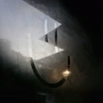 A smiley face is drawn on a foggy surface.