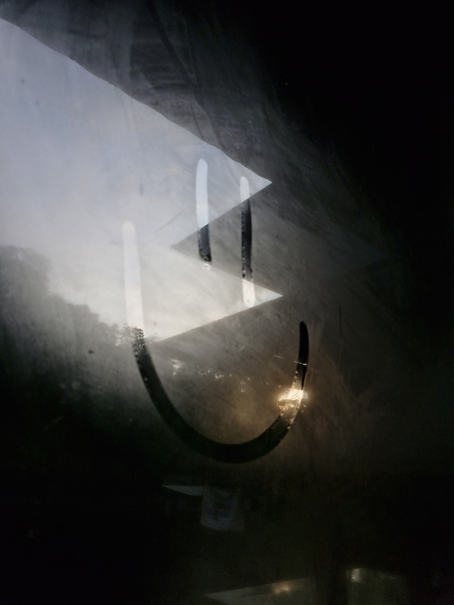 A smiley face is drawn on a foggy surface.