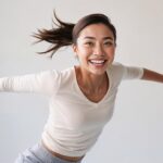 ai generated, woman, laughing, smiling, happy, happiness, jump, freedom, portrait
