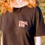 a woman with red hair wearing a black shirt