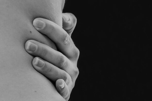 grayscale photo of couple holding hands